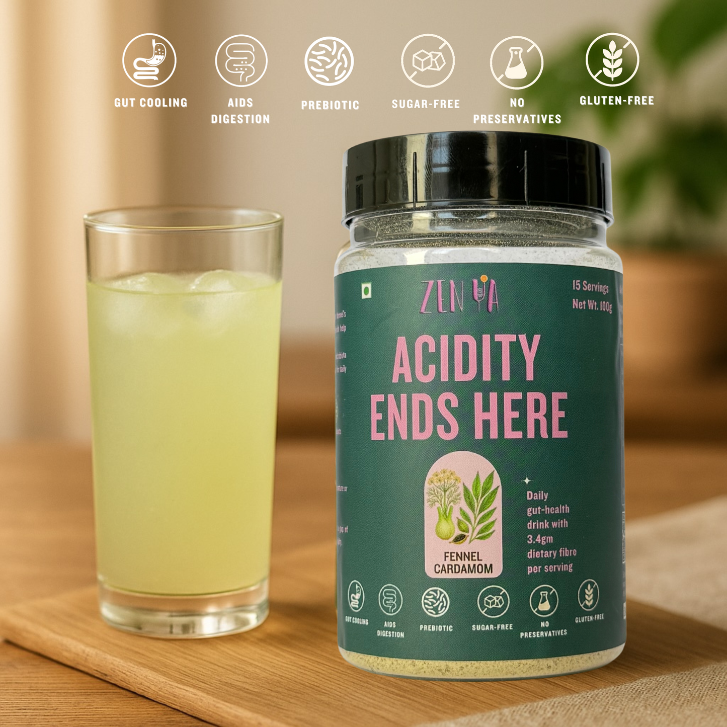 ZenYa Acidity Ends Here fennel–cardamom drink mix jar placed on a wooden table beside a tall glass of pale green herbal drink, styled in a bright, minimal home setting with soft natural light and a blurred plant in the background.