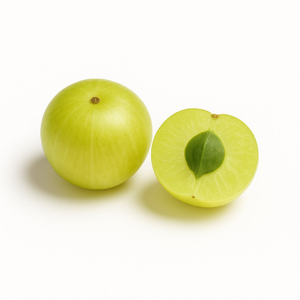 Green fruit, gooseberry, amla with one half showing a green leaf on a white background.