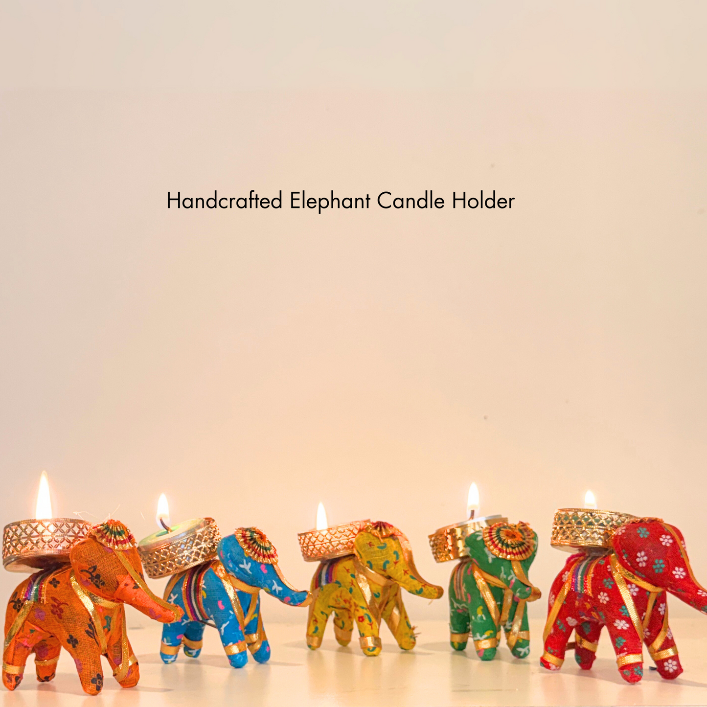 Colorful handcrafted elephant candle holders on a light background
