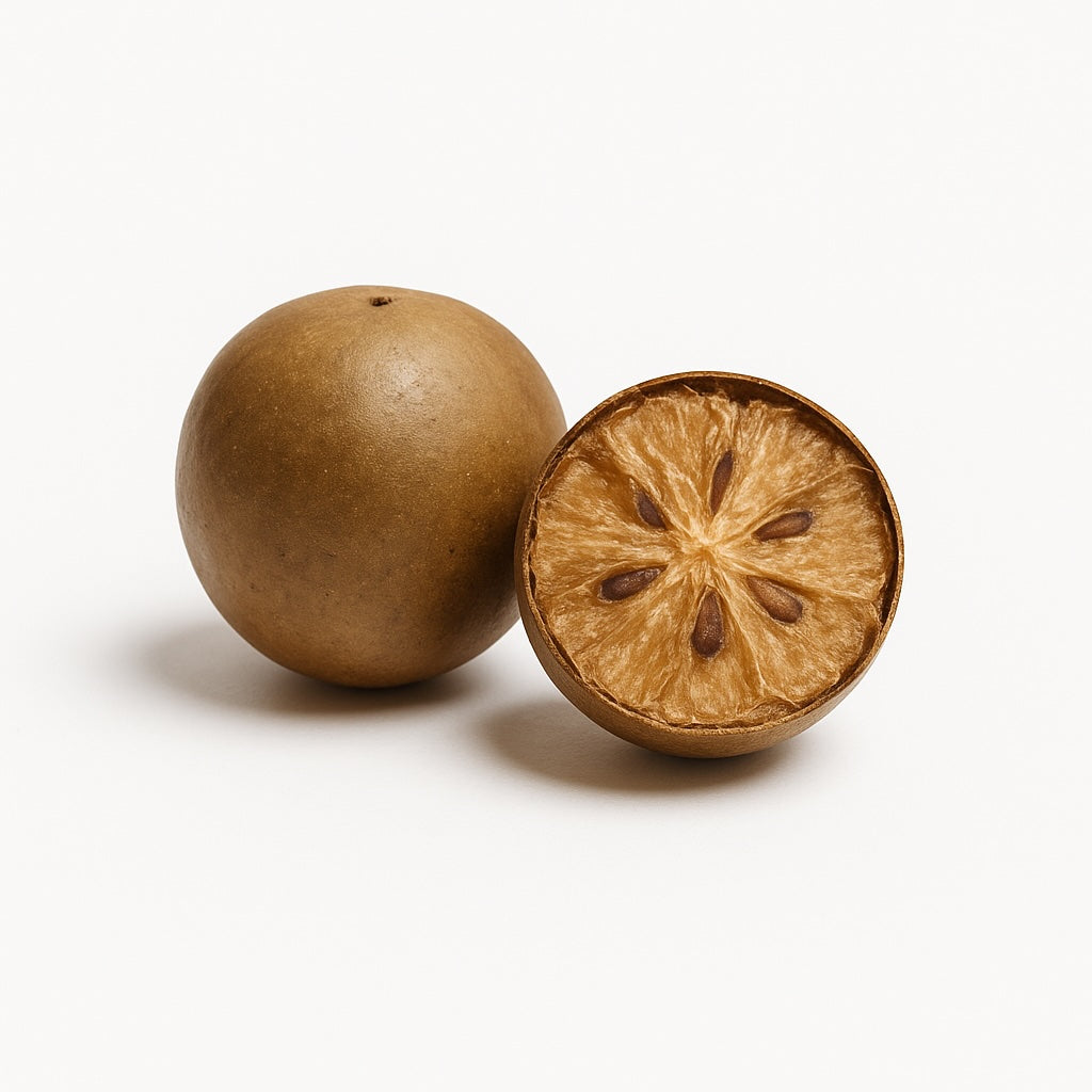 Whole and halved monk fruit on a white background